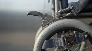 Maneuvering the lightest transport wheelchair through a narrow indoor hallway or clinic setting with ease.