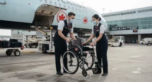 Wheelchair user receiving priority boarding onto a commercial airplane before general passengers.