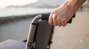 Traveler using the lightest transport wheelchair at a Canadian airport terminal, highlighting portable mobility.