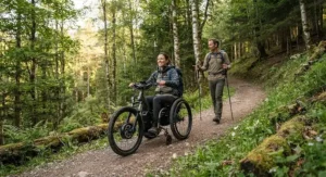 A group of outdoor enthusiasts using trail wheelchairs for wheelchair hikers during an adaptive recreation event in Canada.
