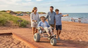 A family smiling together as a loved one uses a beach wheelchair for sand and boardwalks during an accessible summer getaway in Atlantic Canada.